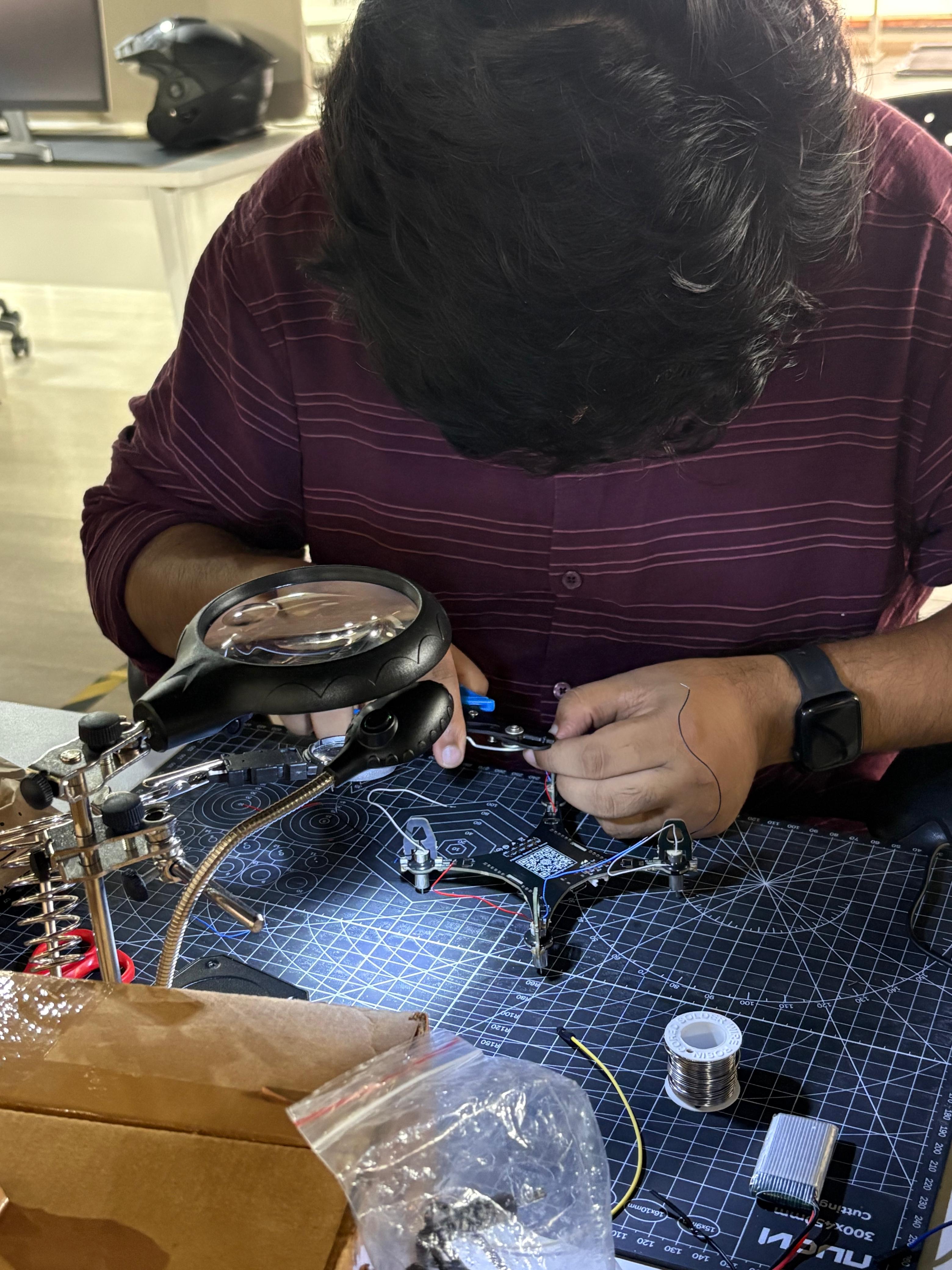 Soldering a drone flight controller at the workbench